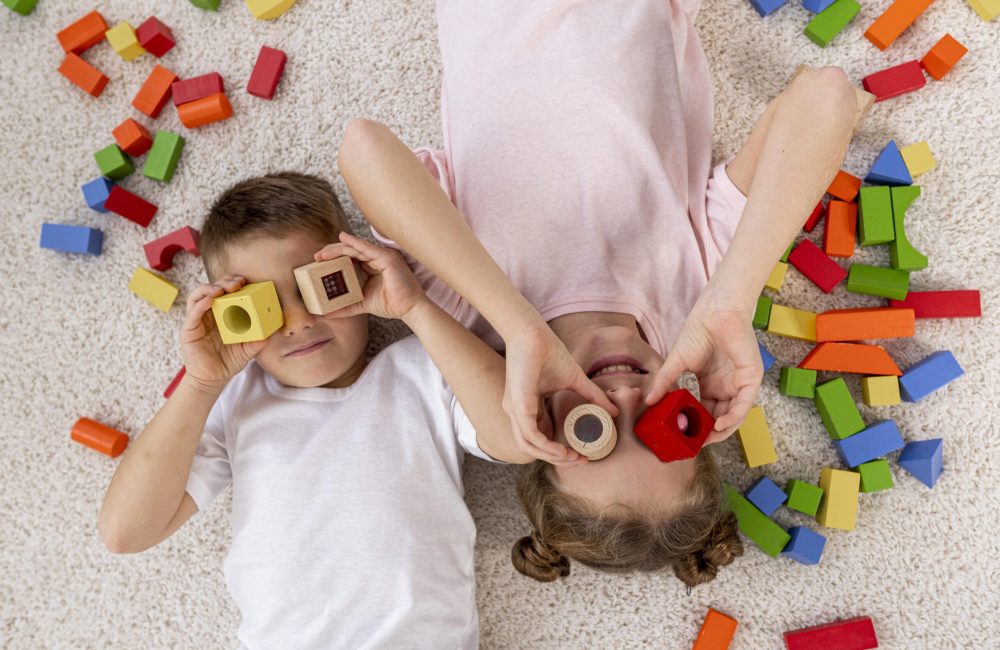 top-view-non-binary-kids-playing-with-colorful-game